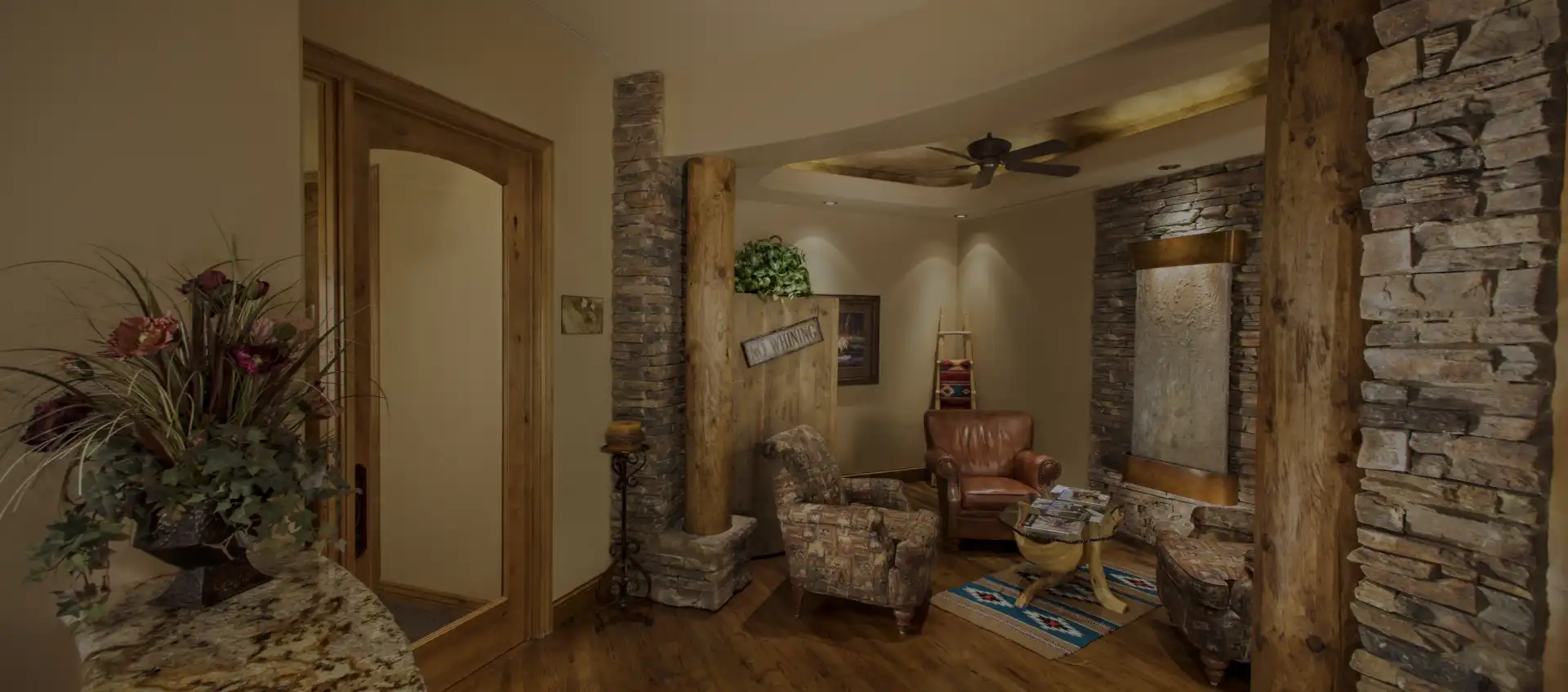 Modern dental office waiting room with comfortable seating, warm lighting, and contemporary decor.